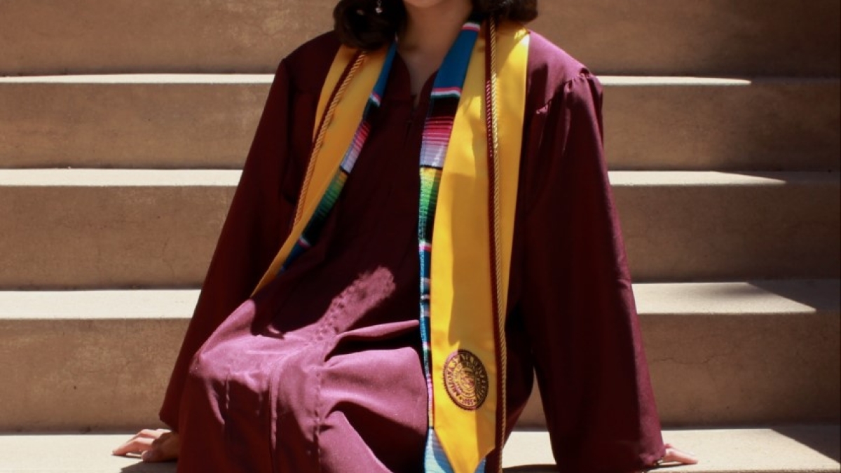 Jennifer Rivera in her ASU cap and gown on steps