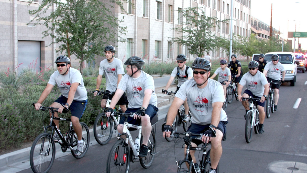 A group of ASU Police Department Officers ride their bicycles together. 