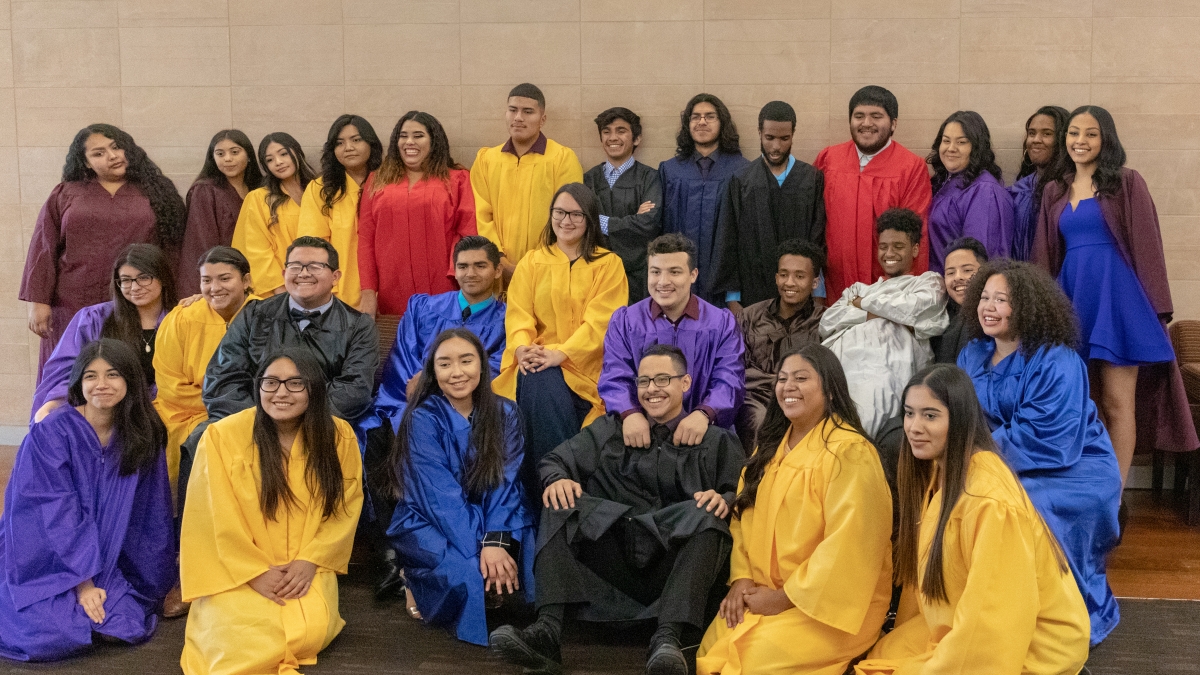 TRIO Upward Bound students pose in their graduation gowns in a spring 2019 celebration at ASU in Tempe