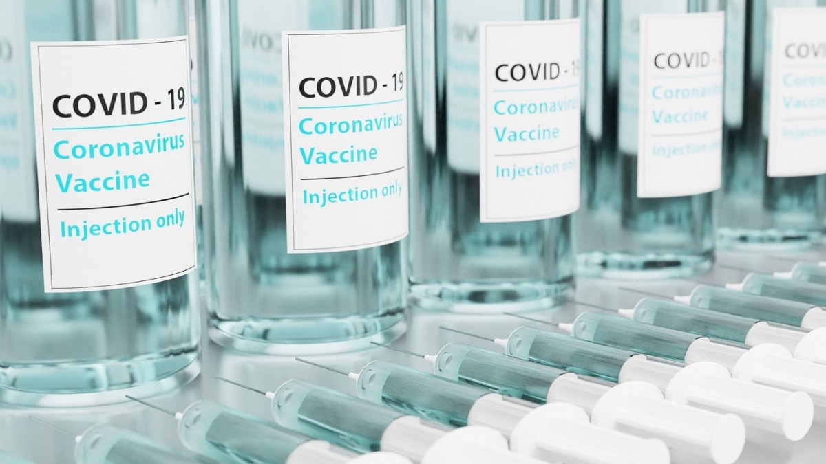 Bottles on a table labeled "Covid-19 Coronavirus Vaccine."
