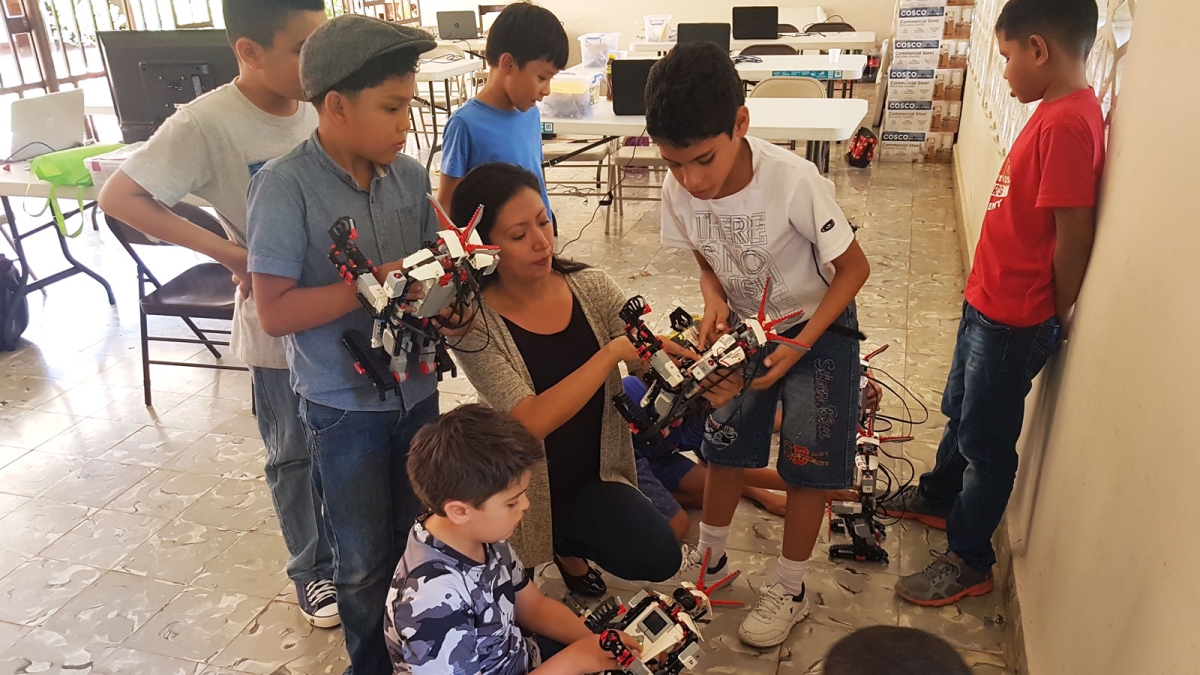 Victoria Serrano shows robots to young students