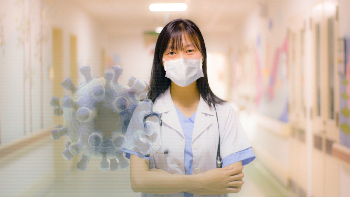 nurse standing with arms folded, virus in foreground