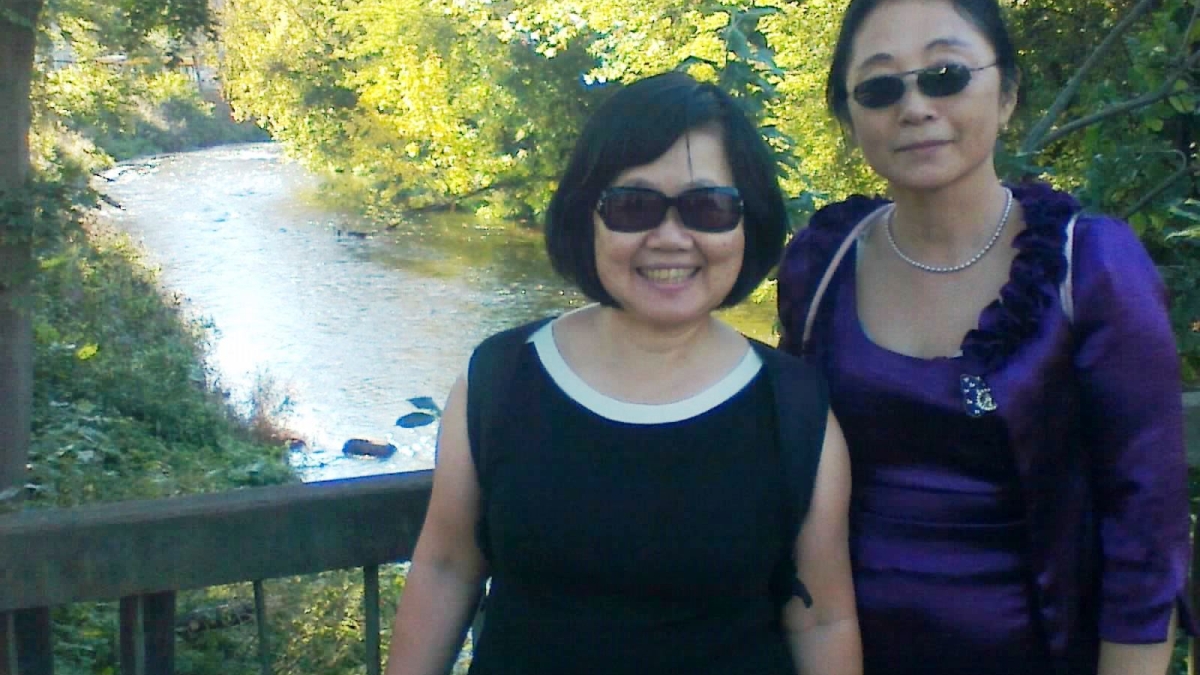 ASU professor Wei Li and colleague Lucio Lo standing on a bridge