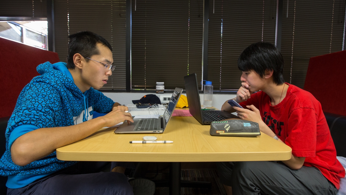 Men studying in a booth.