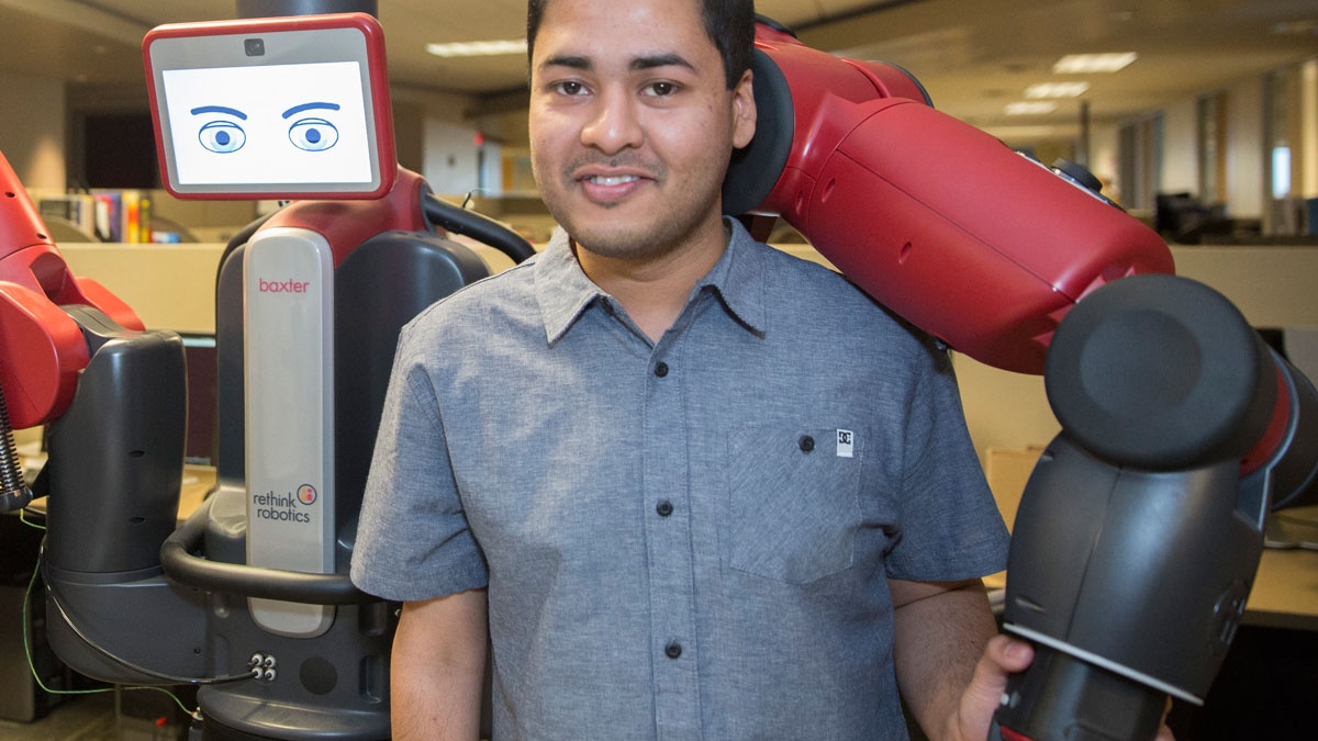 Computer science graduate student Tathagata Chakraborti and the Yochan lab robot Newman