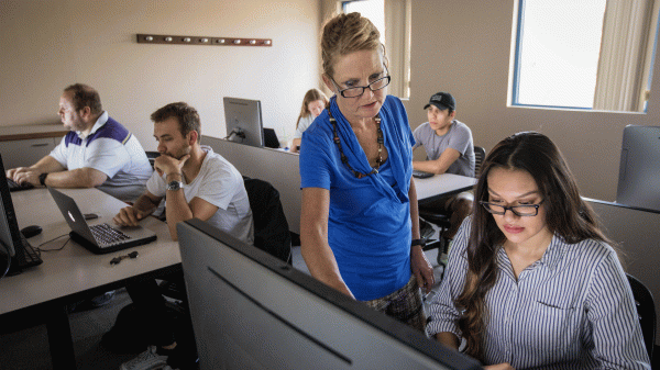 Instructor Elizabeth Ferszt helps a student building a website