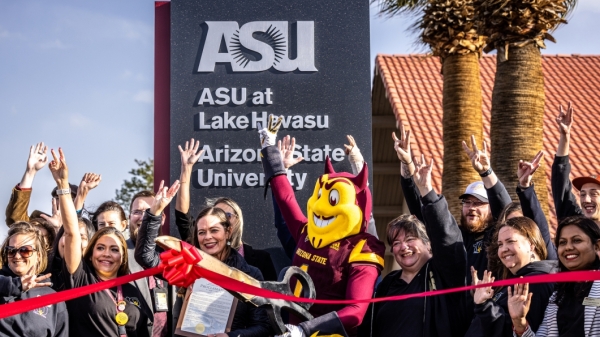 ASU mascot Sparky the Sun Devil and a crowd of people celebrate at a ribbon-cutting ceremony.