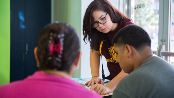 Tatiana Alvarado, 19, speaks to community members who are receiving education about curbing obesity