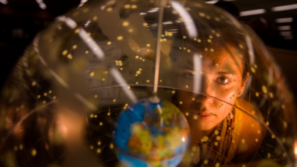Person looking at a globe.
