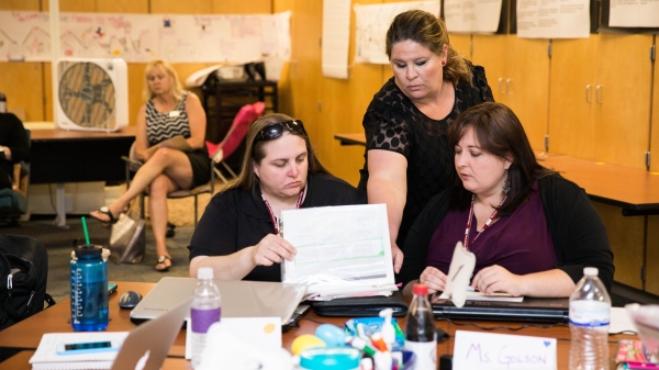 Nicole Aveni assists her students Melissa Sullivan, left, Hillary Golson, right, during their course at Longview School 