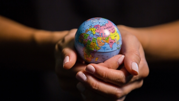 hands holding small globe