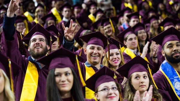 students in caps and gowns at graduation ceremony