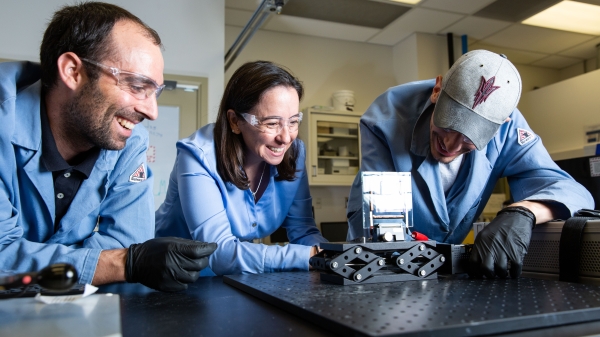 professor working with two students in a lab