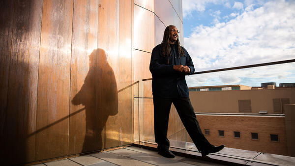 Black man standing near balcony