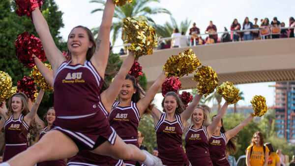 cheerleaders perform at the homecoming parade and block party