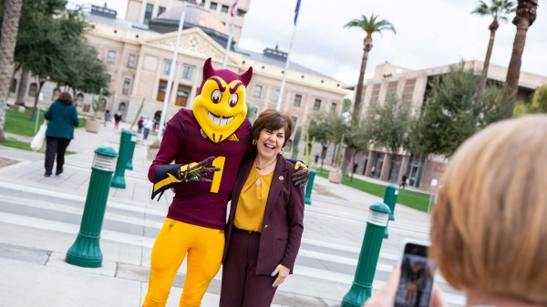 Sparky poses with a legislator at Day at the Capitol