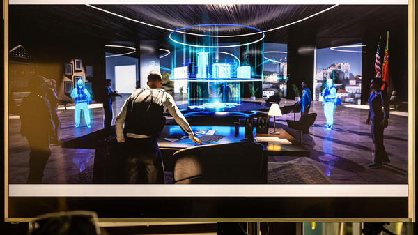 Illustration depicting people around a holographic table in the future.