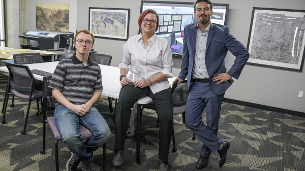From left to right, Eric Friesenhahn, Jill Sherwood and Matthew Toro pose for a photo in the Map and Geospatial Hub with the Esri Special Achievement in GIS Award.