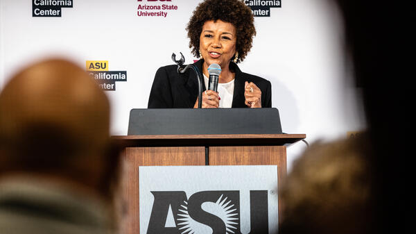 Woman standing behind lectern speaking