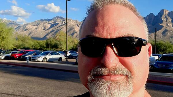 Ted Friedli smiling with mountains in the background