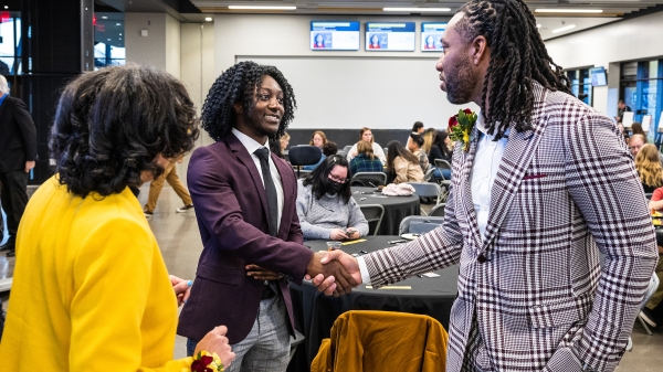 Larry Fitzgerald shaking hands with ASU student at event