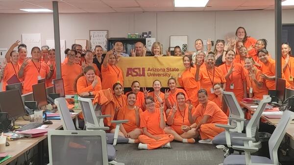 Group of women in prison posing with ASU sign after graduating from program