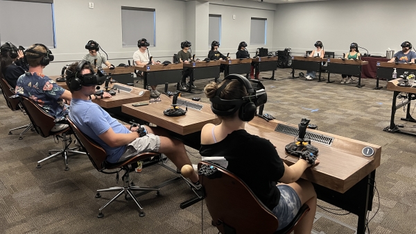 Students sitting in a classroom with VR headsets on.