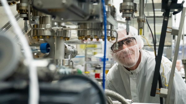 Man looks at equipment in lab