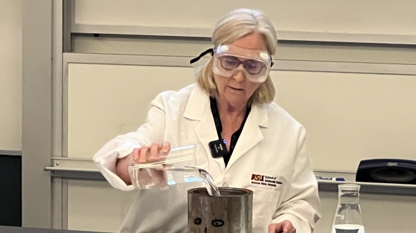 Barbara Munk in a lab working with equipment.