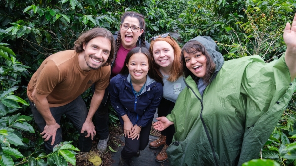 Five students smiling in a lush green Costa Rica forest
