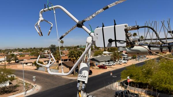 Large machine with sensors suspended above an intersection in a Phoenix neighborhood.