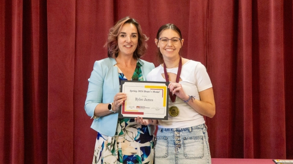 Two women smiling and holding a certificate.