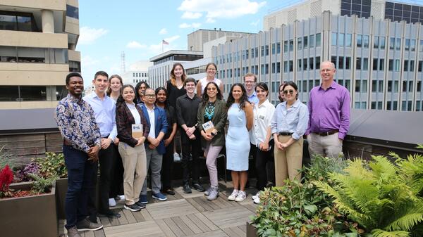 A group of students and staff on the balcony of the ASU Washington Center