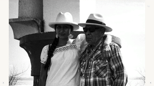 Black-and-white photo of two people wearing hats.