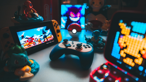 An image of colorful video game equipment and screens in a photo credited to Stewart A. Elrod / Brandon Skeli on Flickr.