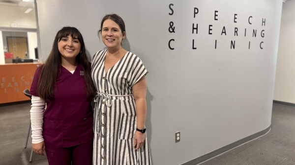 Two women pose in ASU's Speech and Hearing Clinic