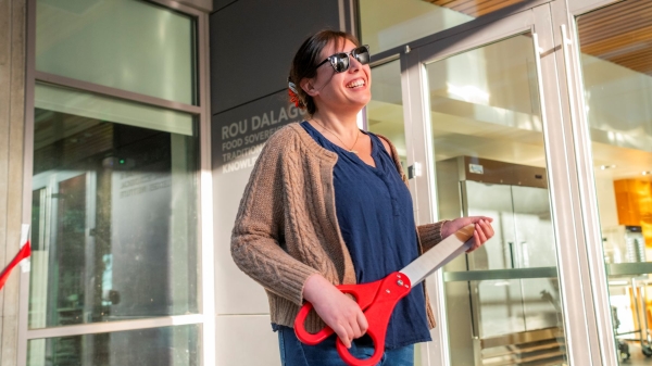 Portrait of Kaitlin Reed holding oversized prop scissors 