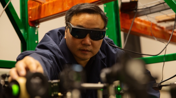 Man wearing glasses working on equipment