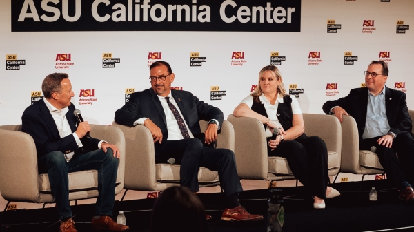 Four people sitting on chairs on stage talking as part of panel under sign that says ASU California Center