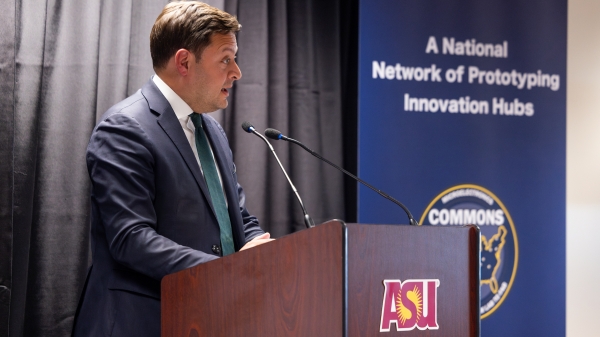 Man speaking at a podium.