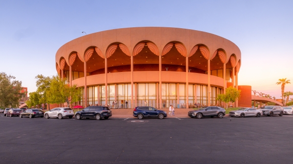 A round, pink building with arches