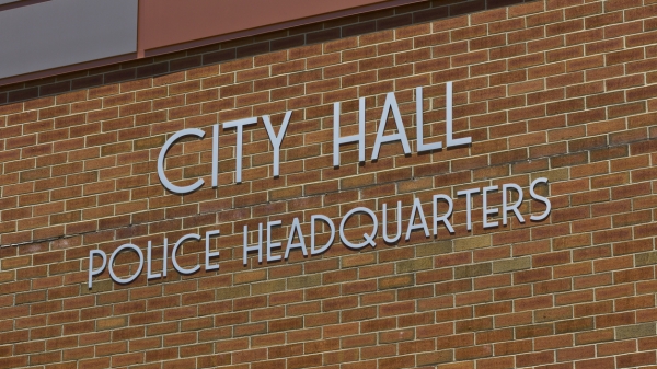 City hall police headquarters sign on a brick building