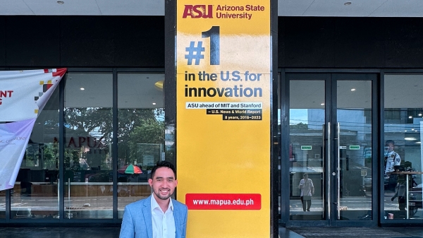 ASU professor Peter Torres standing in front of an ASU banner