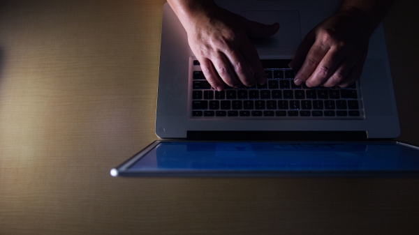 hands typing on a laptop