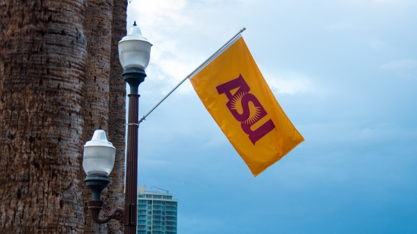 Gold flag with maroon letters that spell ASU on a light post 