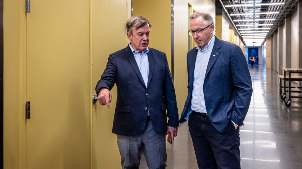 President Crow and Mesa Mayor John Giles walk together down an indoor hallway