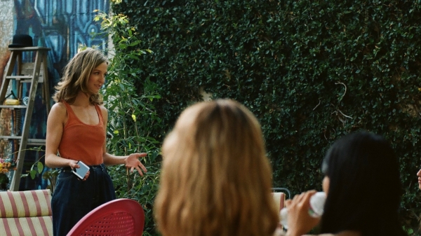 Madison Davis standing in front of a seated crowd