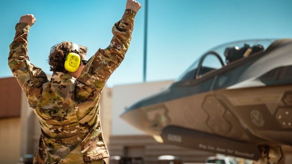 Air Force Airman Abilyn Minton guides an F-35 Lightning II jet fighter fighter at Luke Air Force Base in Arizona.