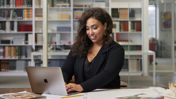 Black woman sitting at desk on laptop