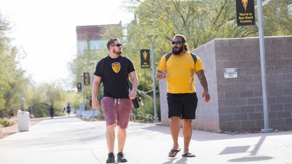 Two student veterans walking and talking on the ASU campus.